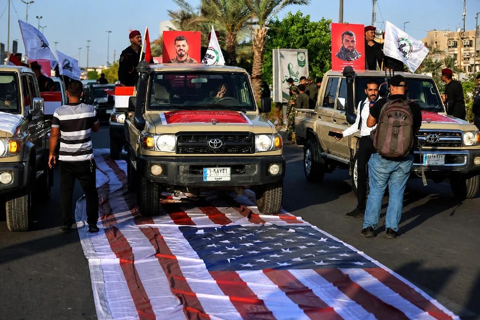 العلم الأمريكي تحت عجلات الحشد.. اختبار السيادة في العراق
